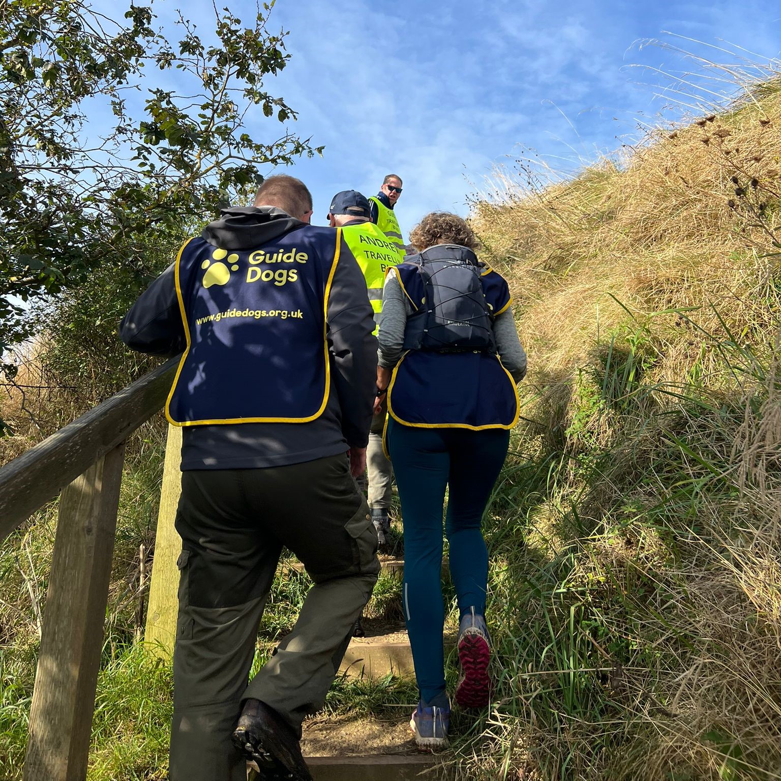 A photo of Andrew with guide's climbing the path at Arthur's Seat